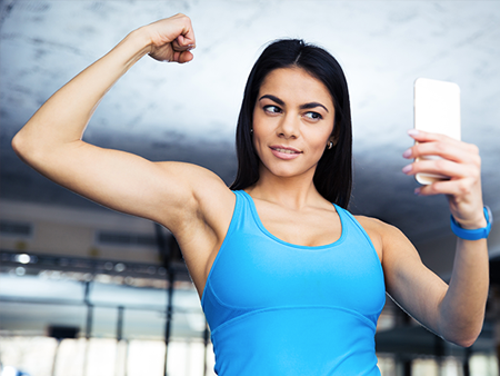 social-media-woman-taking-selfie-at-gym-450x338