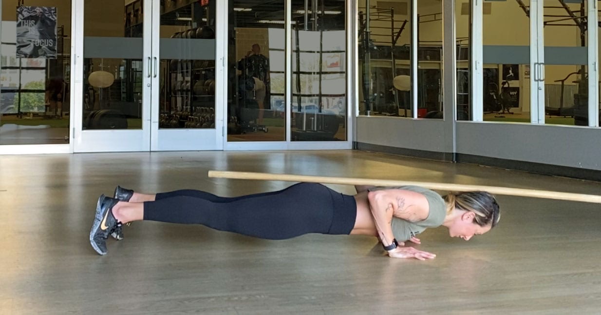 Jen Comas demonstrates proper alignment in the bottom position of a push-up